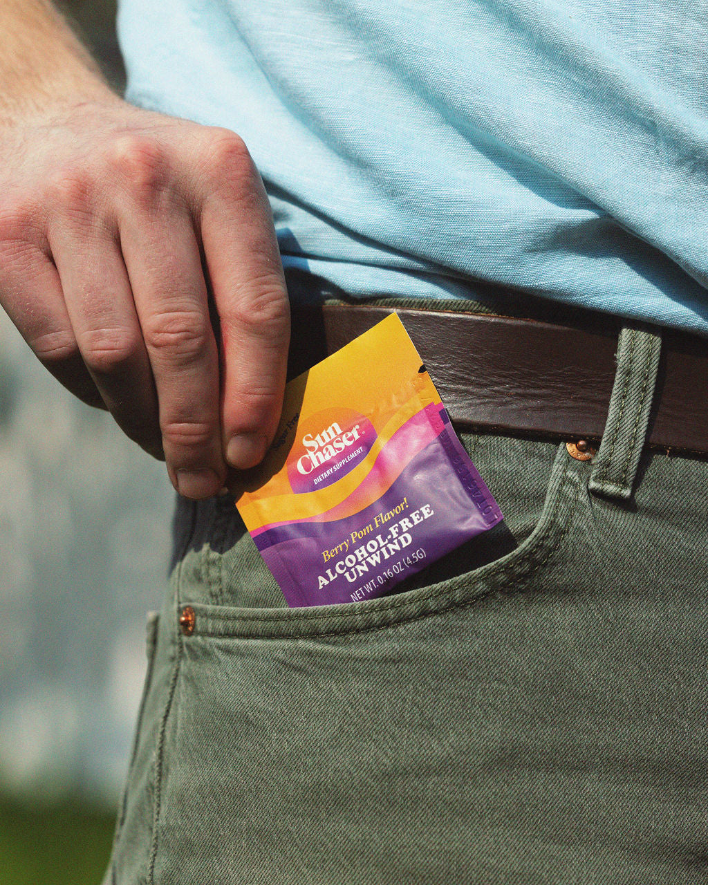 man putting a packet of Sun Chaser in pocket